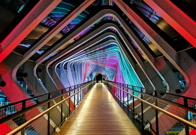 Low angle view of illuminated footbridge at night