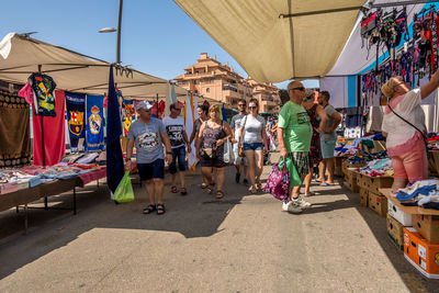 People walking on street market in city