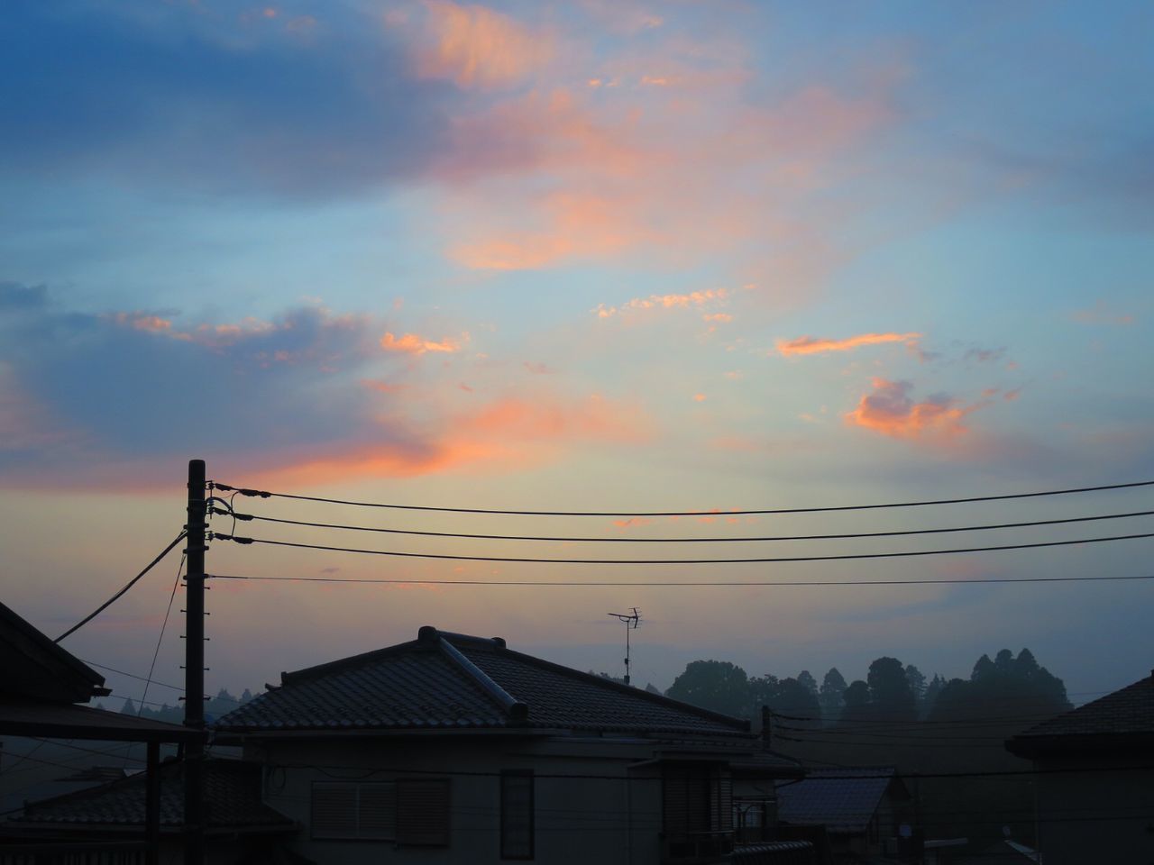 SILHOUETTE BUILDINGS AGAINST ORANGE SKY