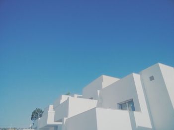 Low angle view of building against clear blue sky