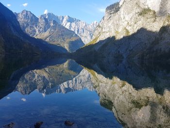 Scenic view of lake and mountains against sky