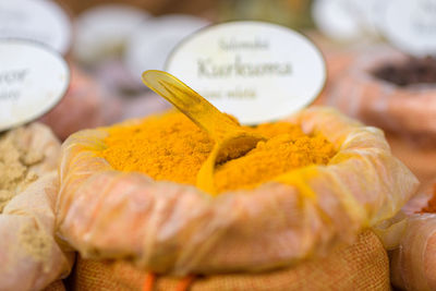 Close-up of bag of yellow spice for sale at market stall