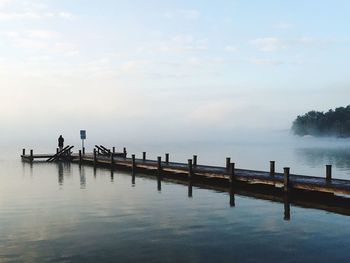 View of jetty at calm sea against the sky