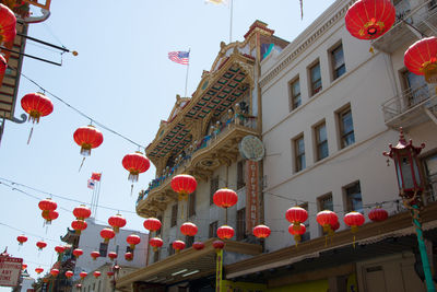 Low angle view of lanterns hanging against sky