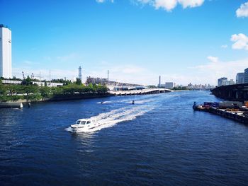 Scenic view of river against sky in city