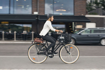 Man riding bicycle on street in city