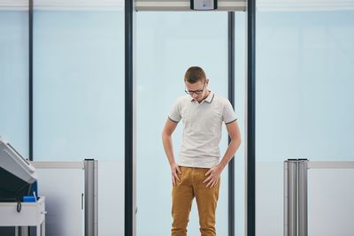 Young man looking through window