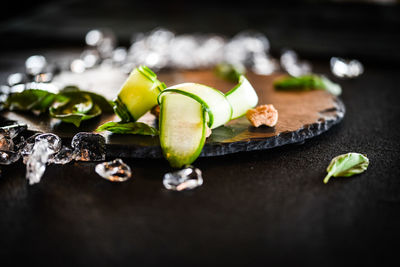 Close-up of fruits and leaves on table