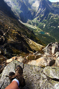 Low section of man standing on rock