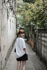 Rear view of woman walking on street