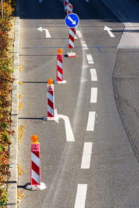 High angle view of arrow sign on road in city