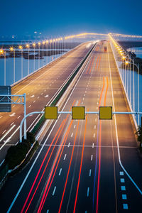 High angle view of light trails on highway at night