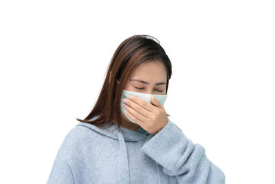Portrait of woman wearing hat against white background