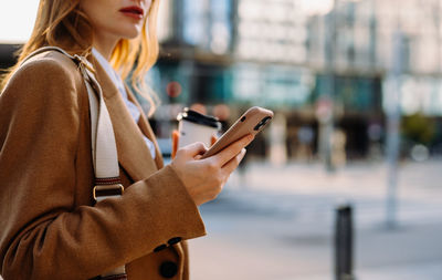 Midsection of woman using mobile phone