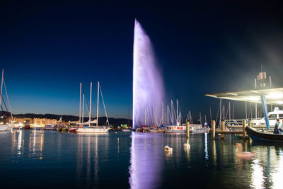 Sailboats in sea at night