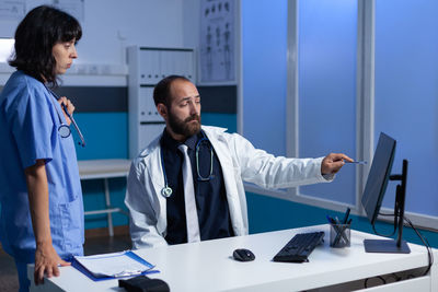 Doctor having discussion with nurse in clinic