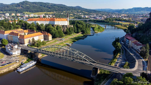 High angle view of bridge over river amidst buildings in city