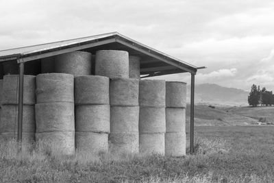 Built structure on field against sky