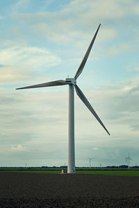 Low angle view of windmill against sky