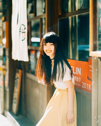 Portrait of smiling young woman standing outdoors