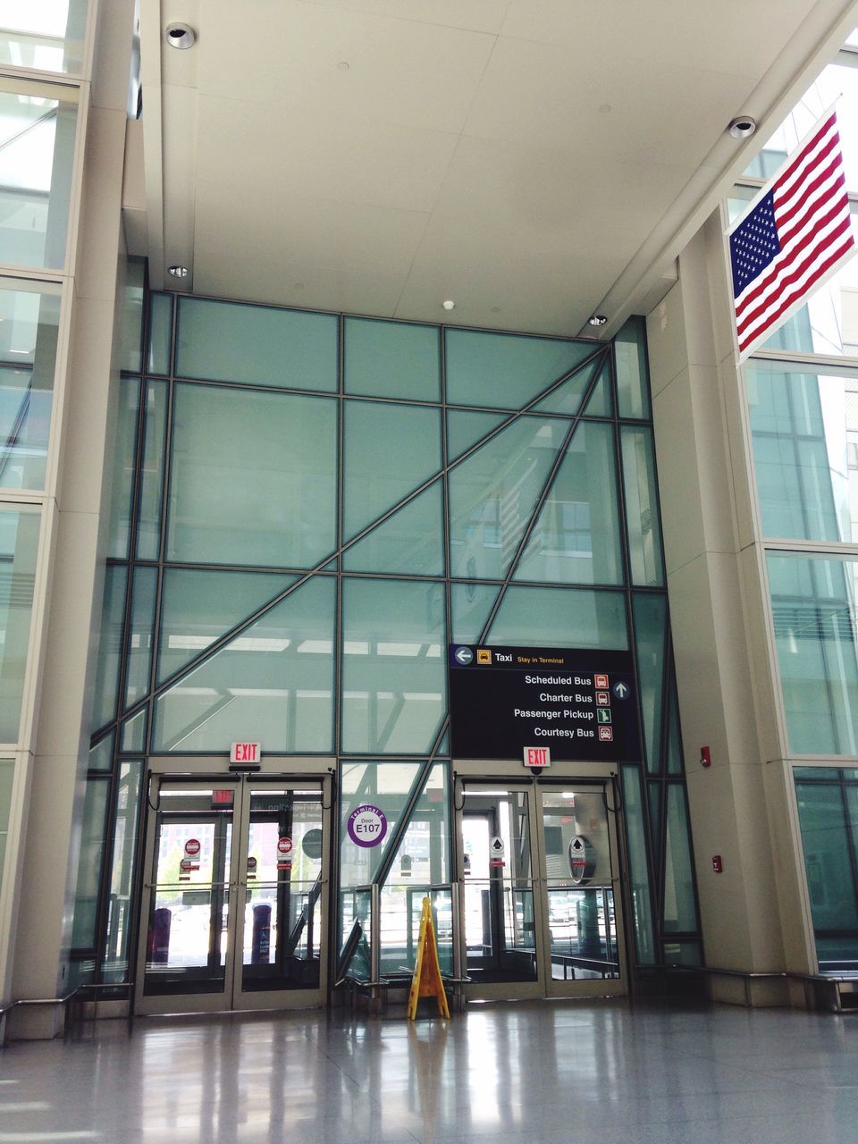 indoors, text, architecture, built structure, western script, communication, window, glass - material, reflection, interior, ceiling, modern, information sign, transparent, no people, transportation, day, non-western script, wall - building feature, building