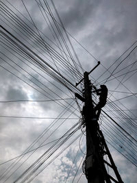 Low angle view of electricity pylon against sky