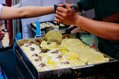 Close-up of man preparing food in kitchen