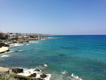 Scenic view of sea against clear blue sky