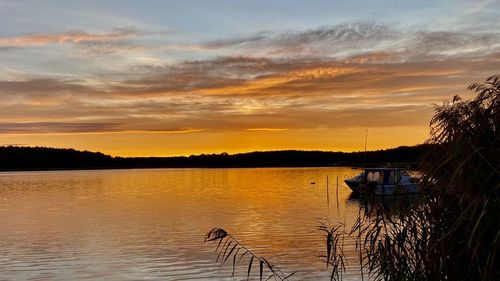 Scenic view of lake against sky during sunset