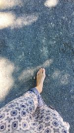 Low section of woman standing on beach