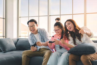 Friends sitting on sofa