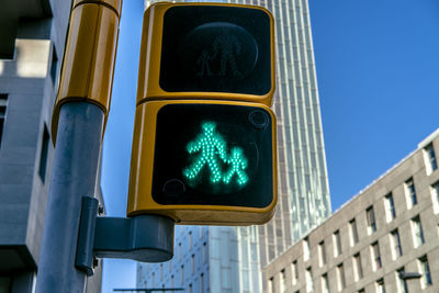 Low angle view of road signal against buildings