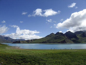 Scenic view of lake and mountains against sky