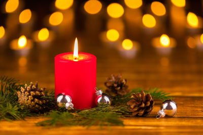 Close-up of illuminated tea light candles on table