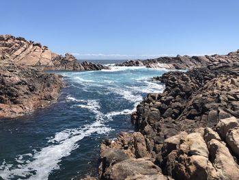 Scenic view of sea against clear blue sky