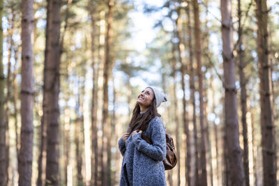 Woman looking away in forest