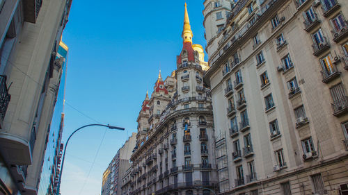 Low angle view of buildings against blue sky