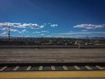Railroad station platform against blue sky
