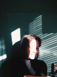 Portrait of woman against wall at home