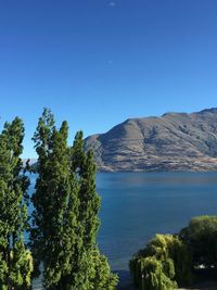 Scenic view of mountains against clear blue sky