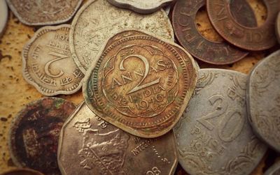 High angle view of coins on metal