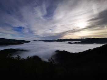 Scenic view of lake against sky at sunset