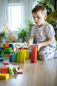 Portrait of cute baby boy playing with toys