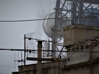 Low angle view of telephone pole against sky