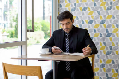 Young man sitting on table
