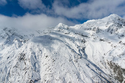 Scenic view of snow covered mountains against sky