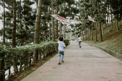 Two kids playing kite in the park