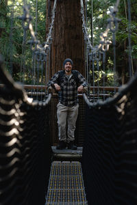 Portrait of man standing in forest