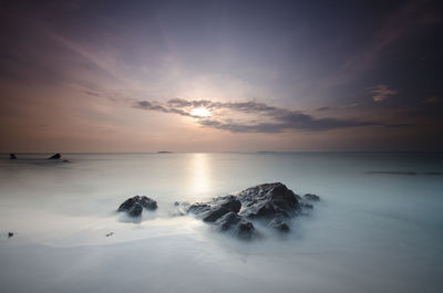 Scenic view of sea against sky at sunset