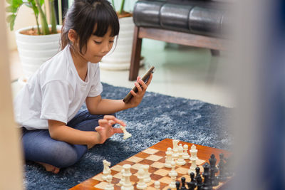 Boy playing with baby sitting on floor